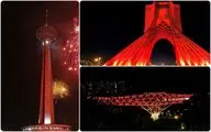 Three iconic structures of Tehran lit up red to mark World AIDS Day