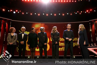 Members Stephanie Zacharek_ Ryuichi Sakamoto_ Adele Romanski_ Chema Prado_ Cecile de France_ Jury President Tom Tykwer and Host Anke Engelke are seen on stage at the closing ceremony during the 68th Berlinale International Film Festival
